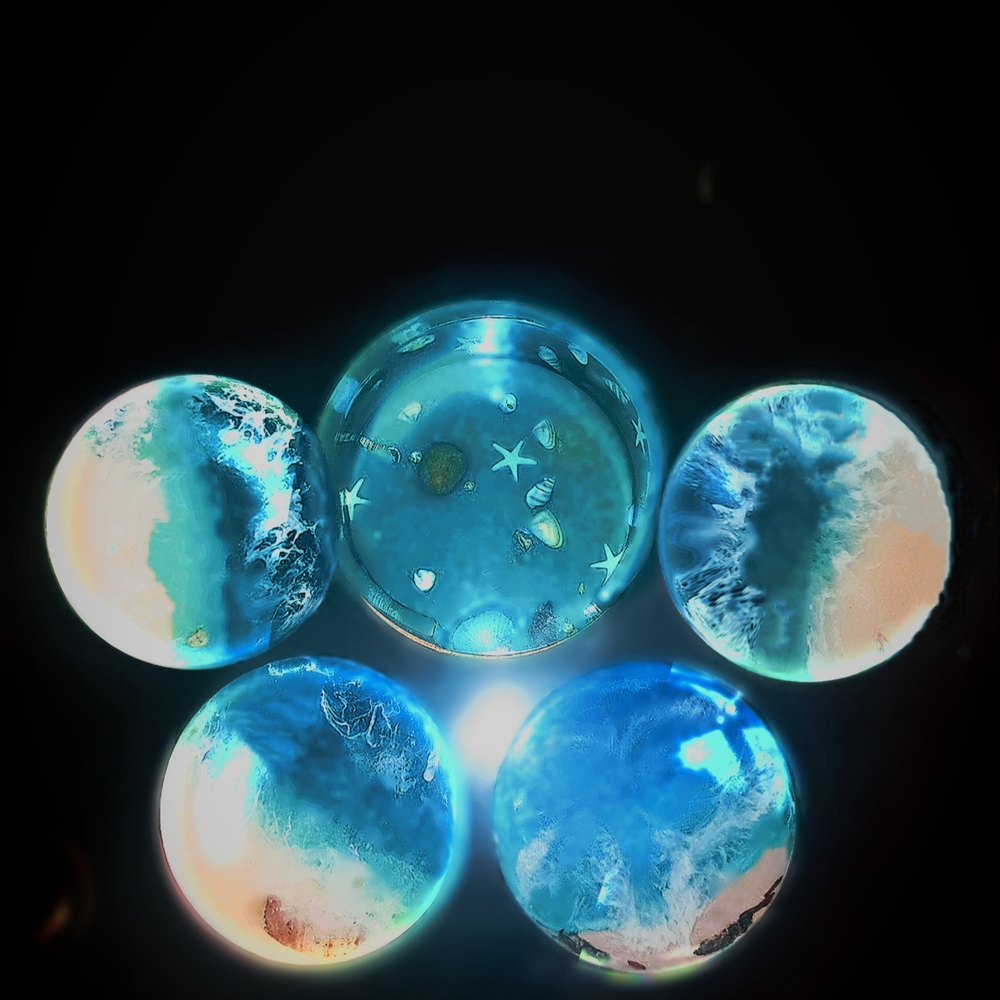 Set of Four Customized Resin Coasters With A Colorful Translucent Ocean Scene.